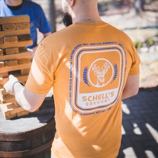 Yellow t-shirt with Schell logo on front and back.