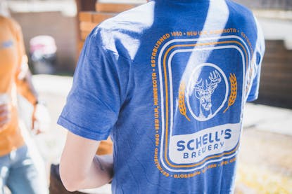 Blue t-shirt with Schell logo on front and back.