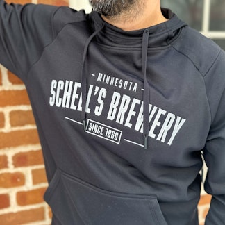 Black hooded sweatshirt with Schell logo on front.