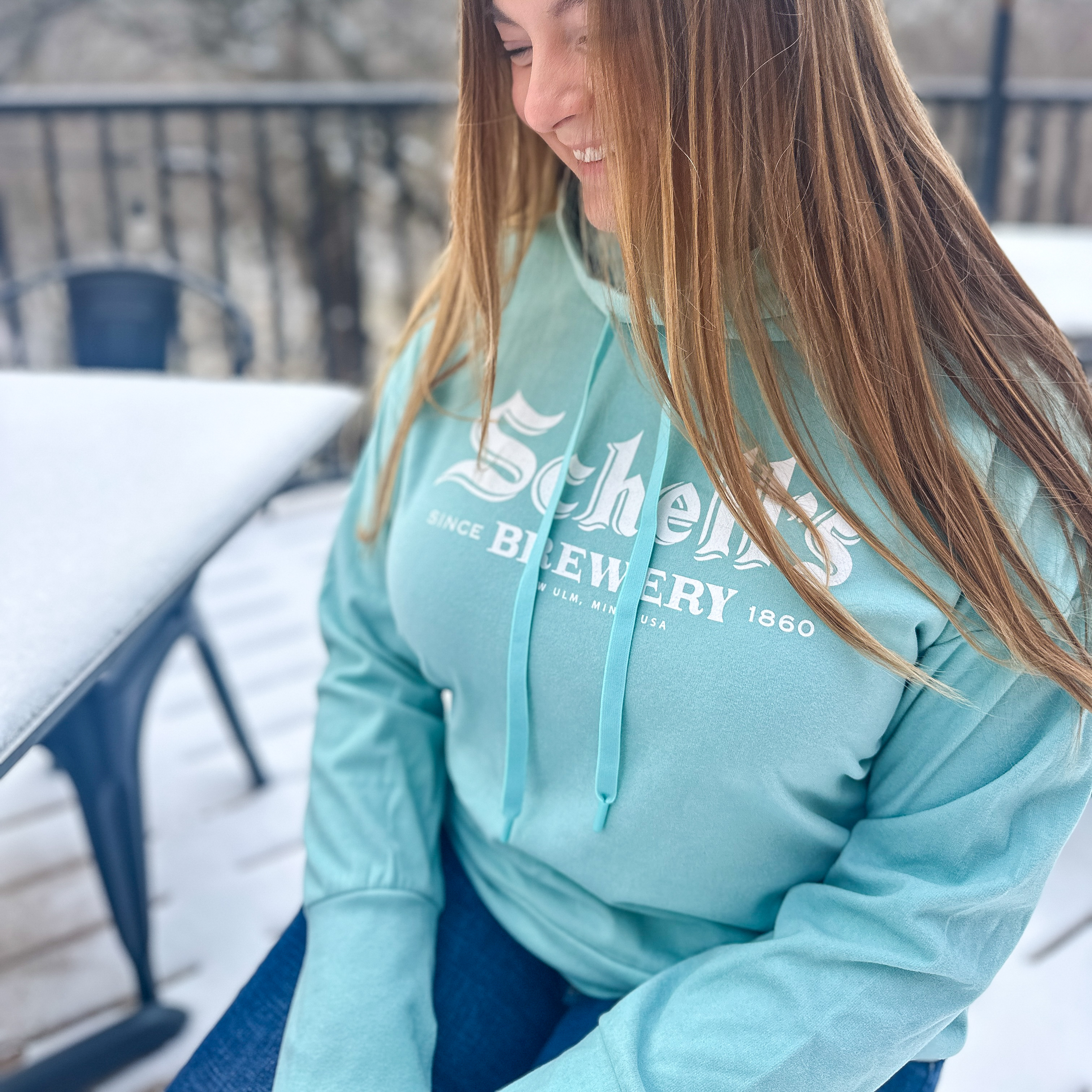Light blue sweatshirt with Schell logo on front in white.
