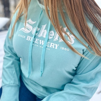 Light blue sweatshirt with Schell logo on front in white.