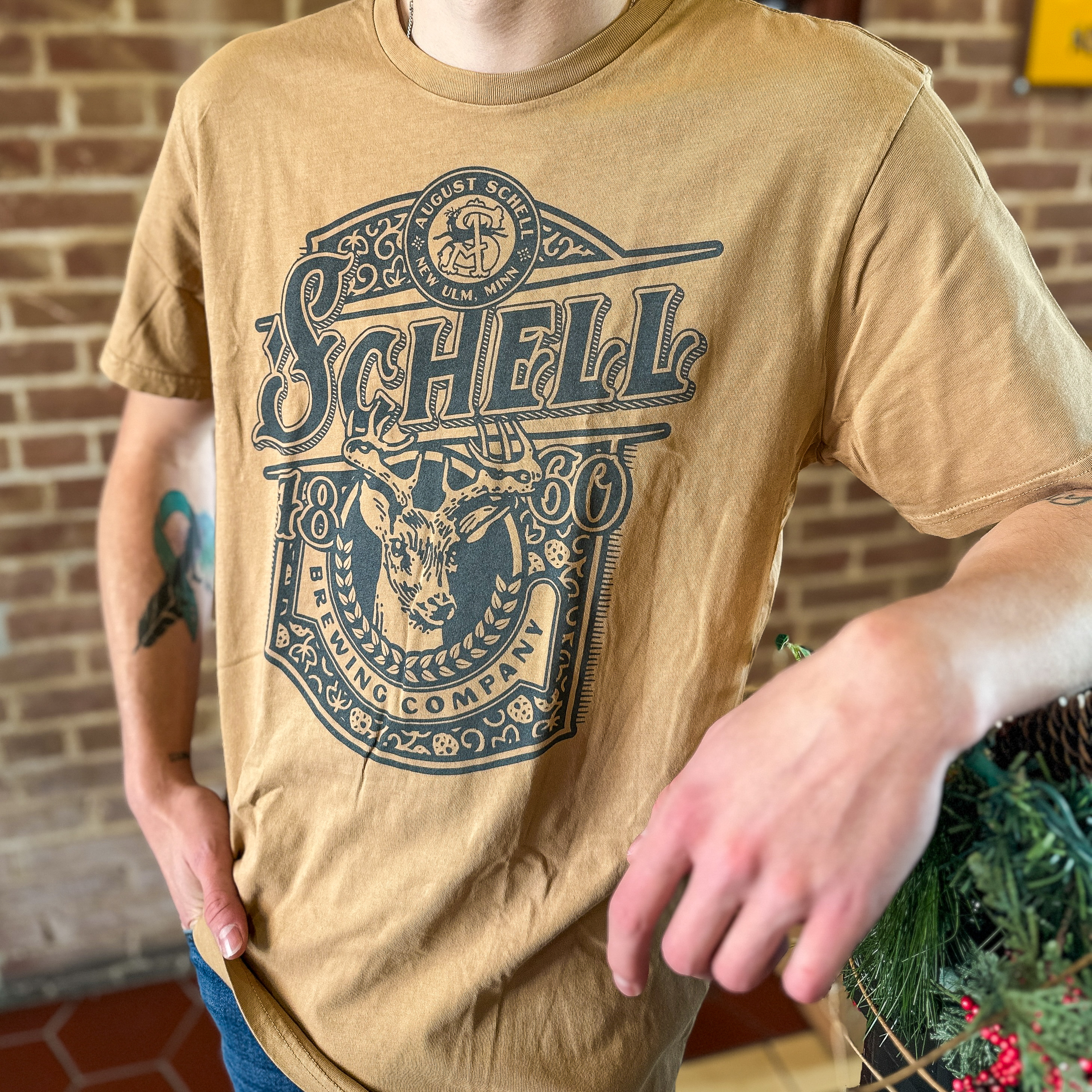 Spice colored t-shirt with Schell logo on front.