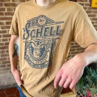 Spice colored t-shirt with Schell logo on front.