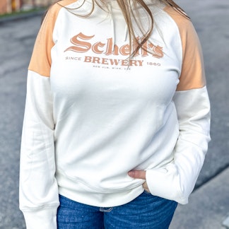 White and peach colored hood with Schells logo on front.