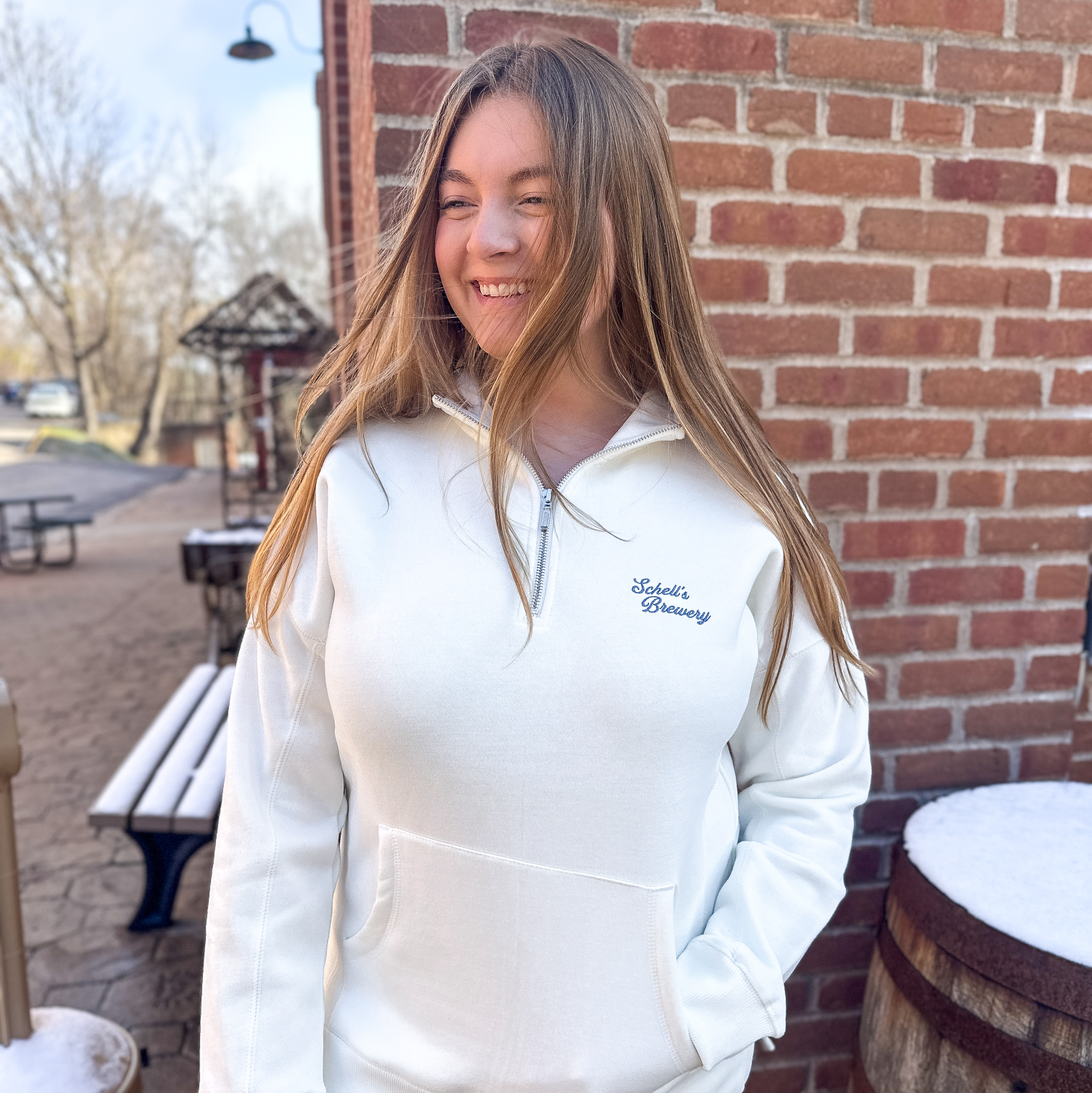 White quarter zip with Schells on front.