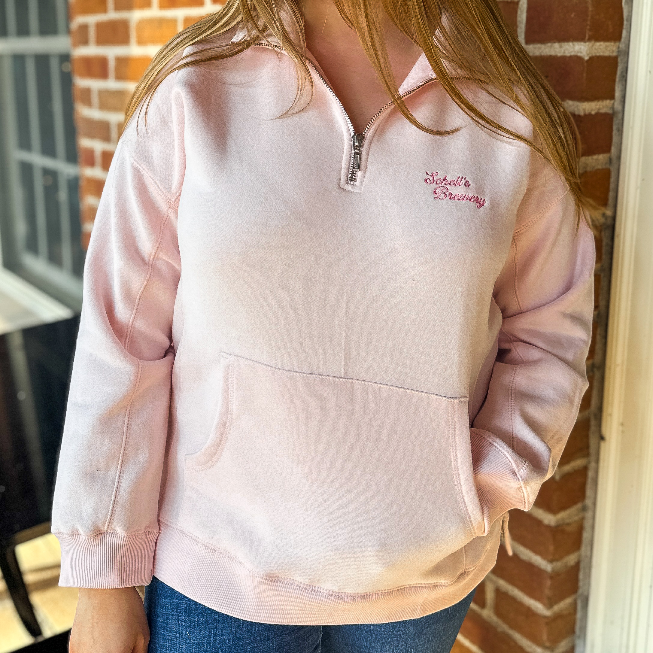 Pink quarter zip with Schells on front.