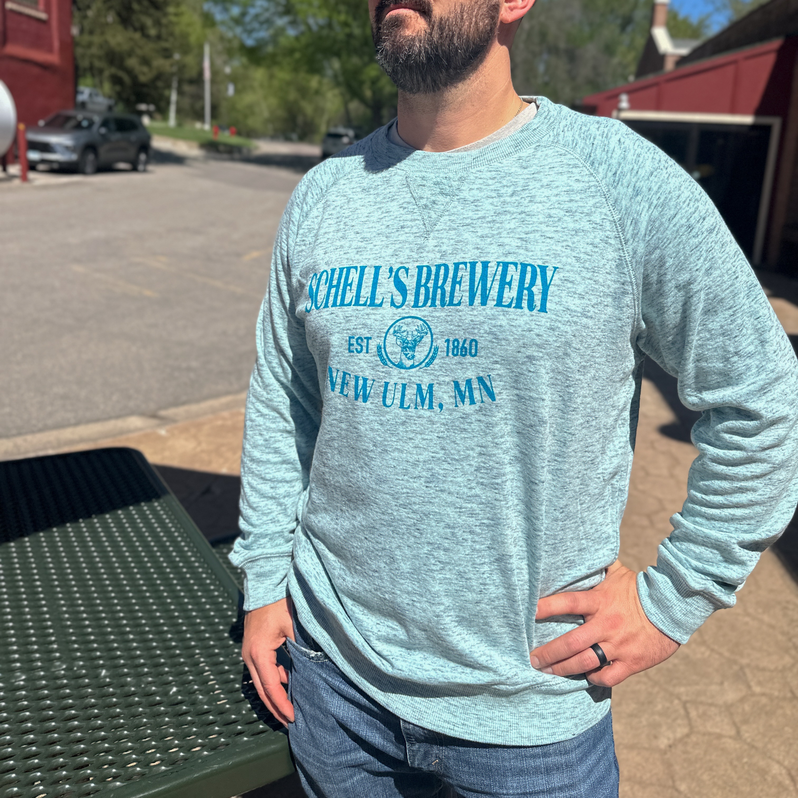 Aqua blue heather crew sweatshirt with Schell logo on the front.