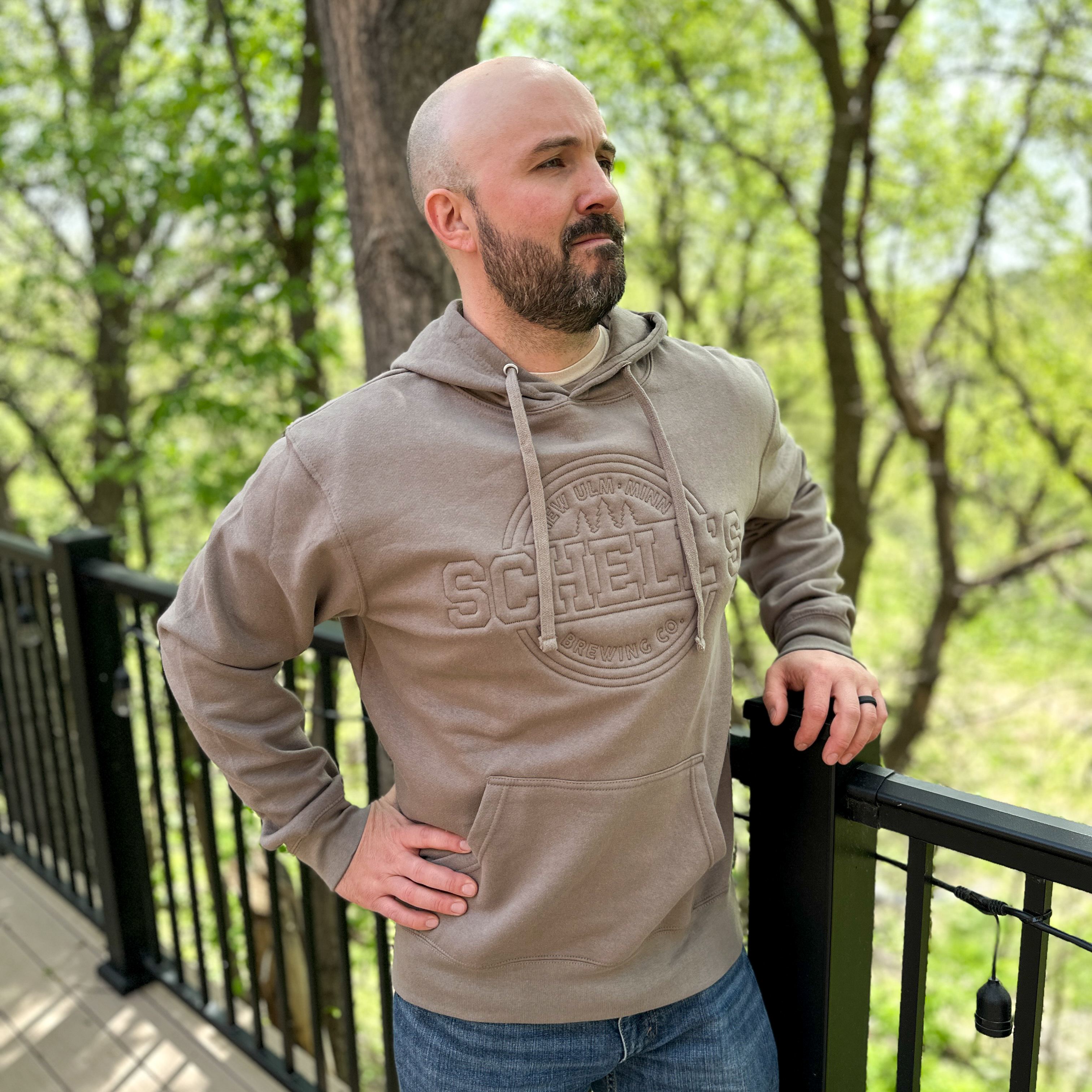 Brown hooded sweatshirt with Schell logo stitched into the front.