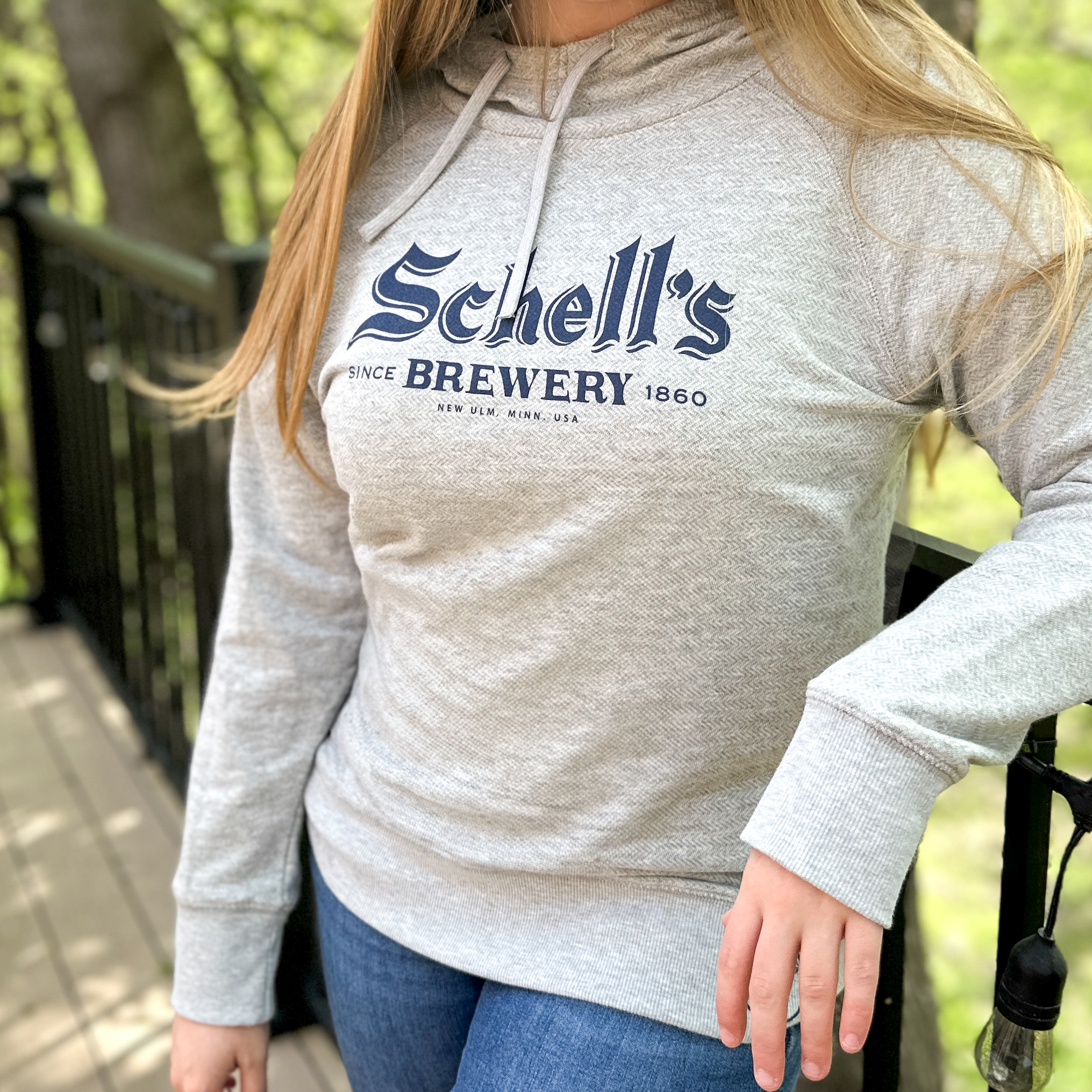 Heather grey sweatshirt with Schells logo on the front.
