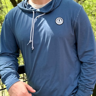 Navy blue lightweight hooded sweatshirt with Schell patch on the left lapel.