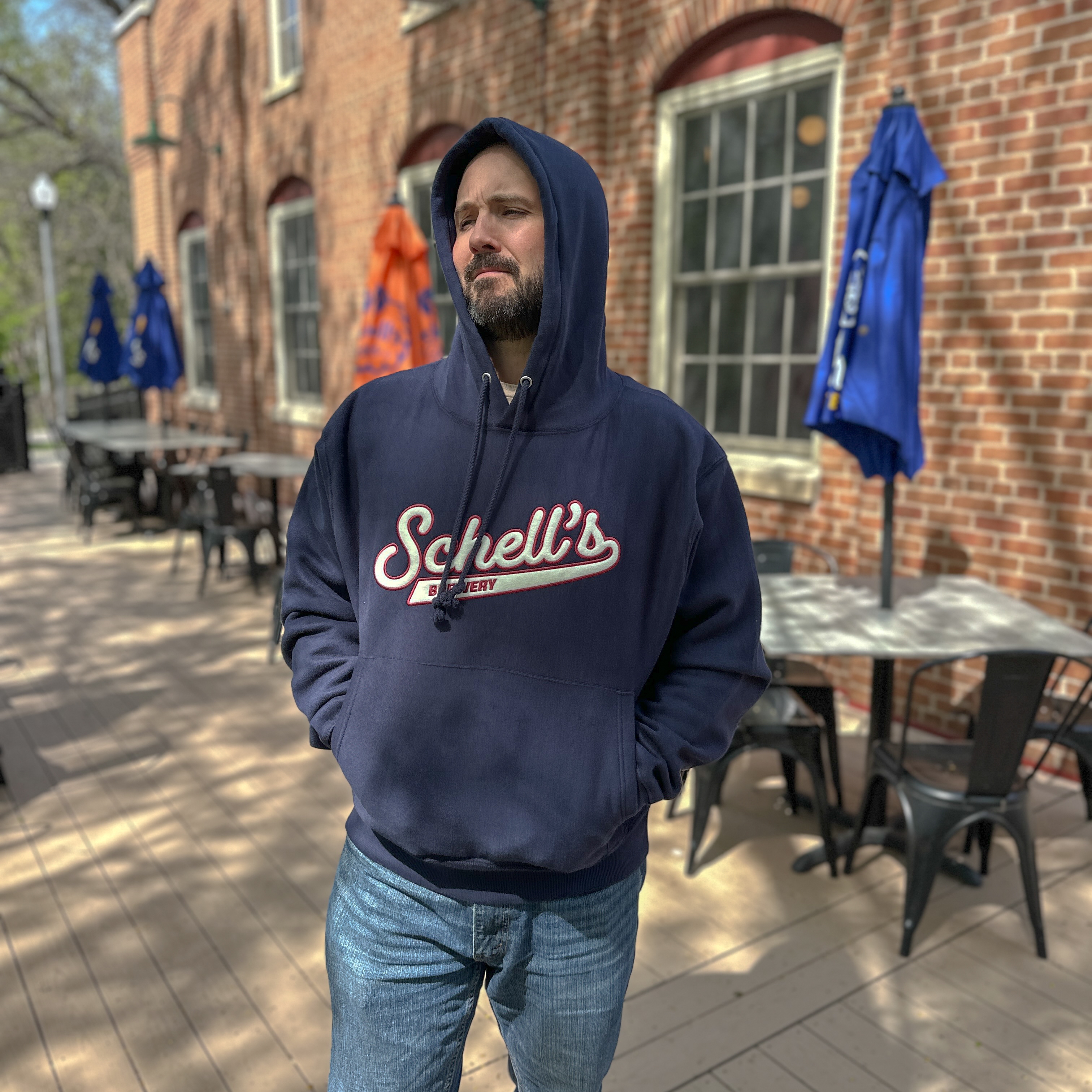 Navy hooded sweatshirt with felt Schell patch on the front.