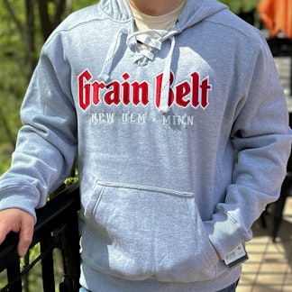 Grey hooded sweatshirt with white hockey ties and Grain Belt across the chest.