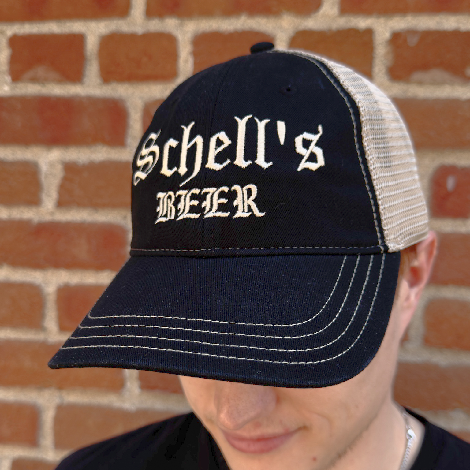 Black and khaki baseball hat with Schells beer on the front.