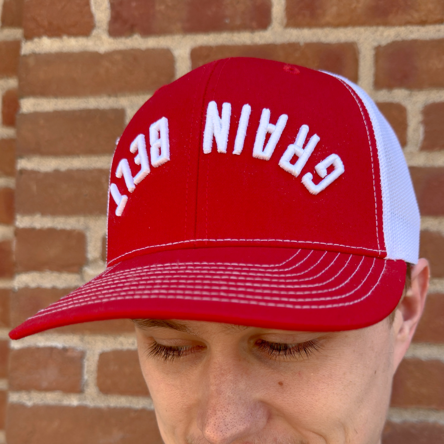 Red and white baseball hat with Grain Belt on the front.