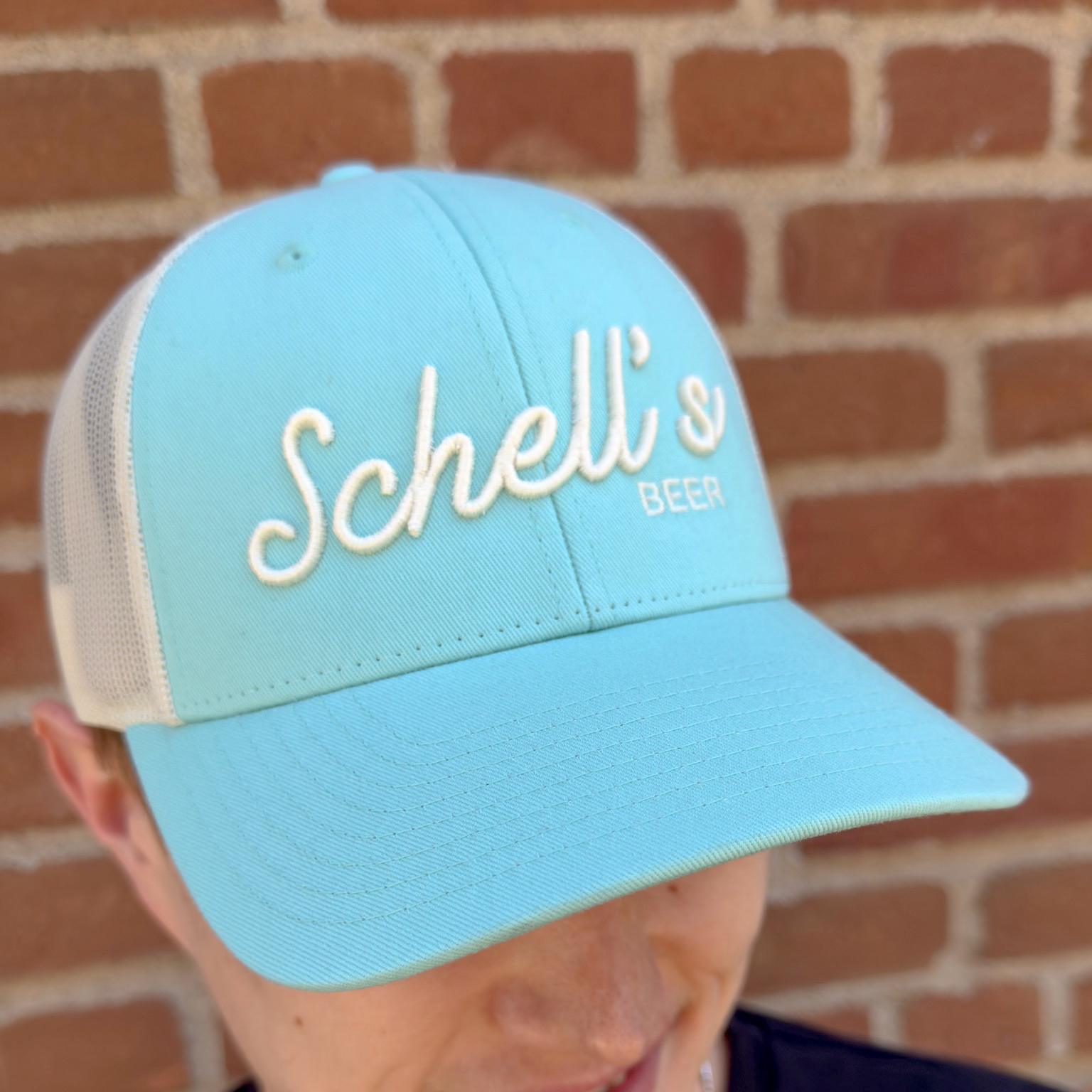 Blue and white baseball hat with Schells on the front.