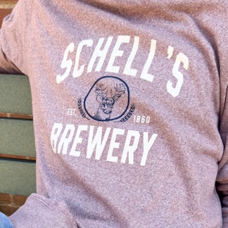 Red heather crew sweatshirt with Schell Logo on the front.