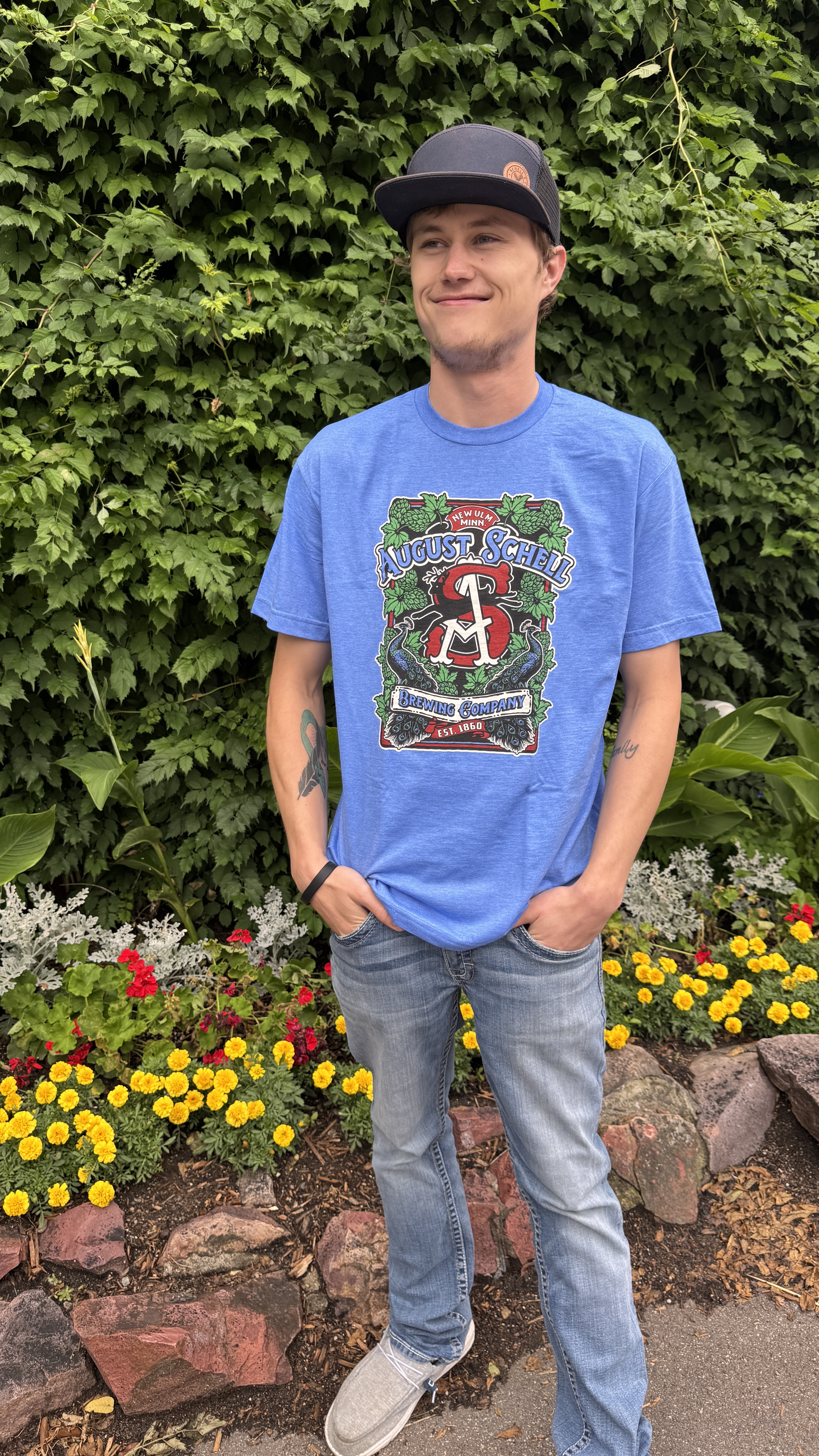 Blue t-shirt with Schell logo on front.