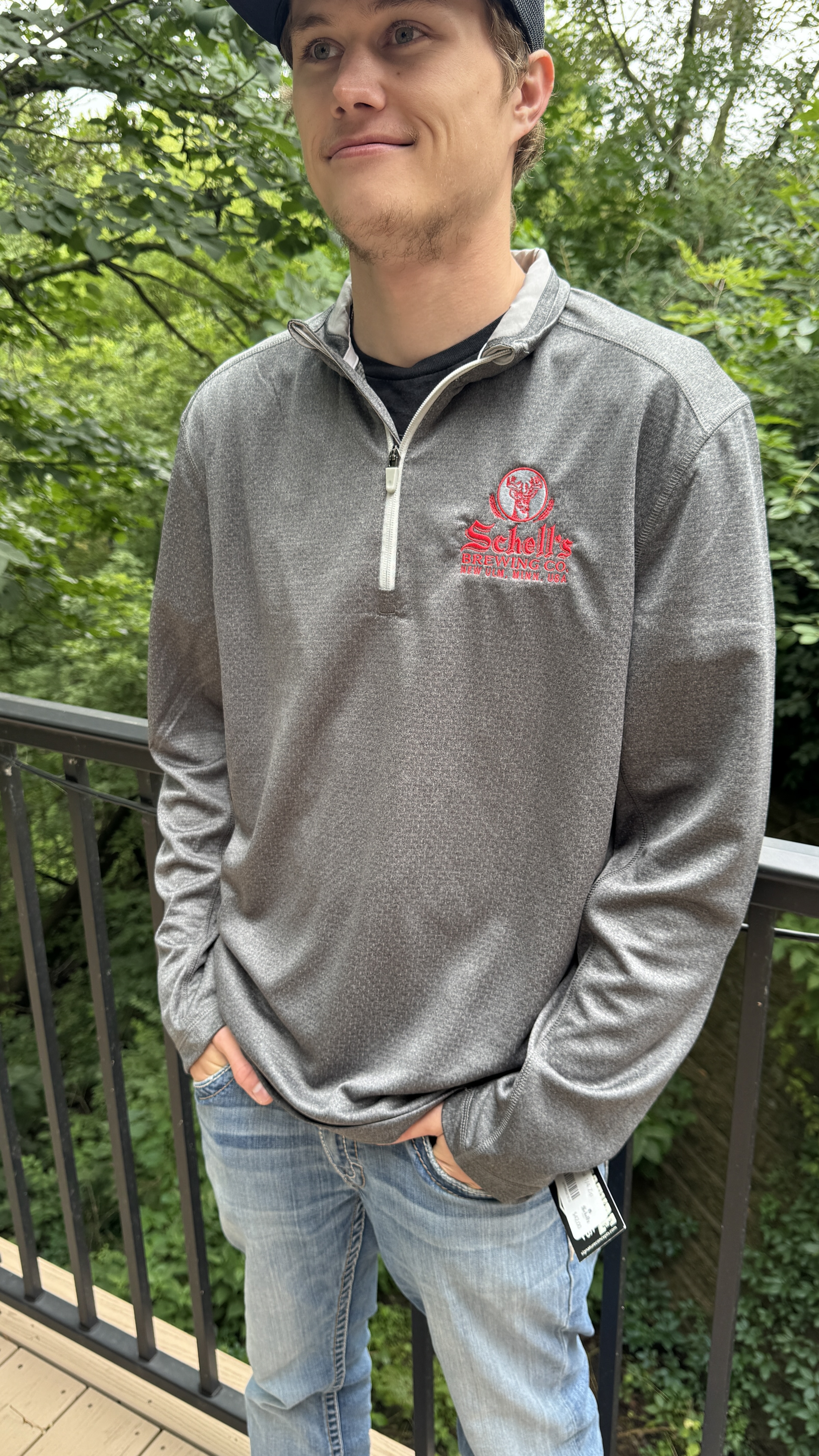 Charcoal Grey quarter zip sweatshirt with Schell logo embroidered on left lapel.