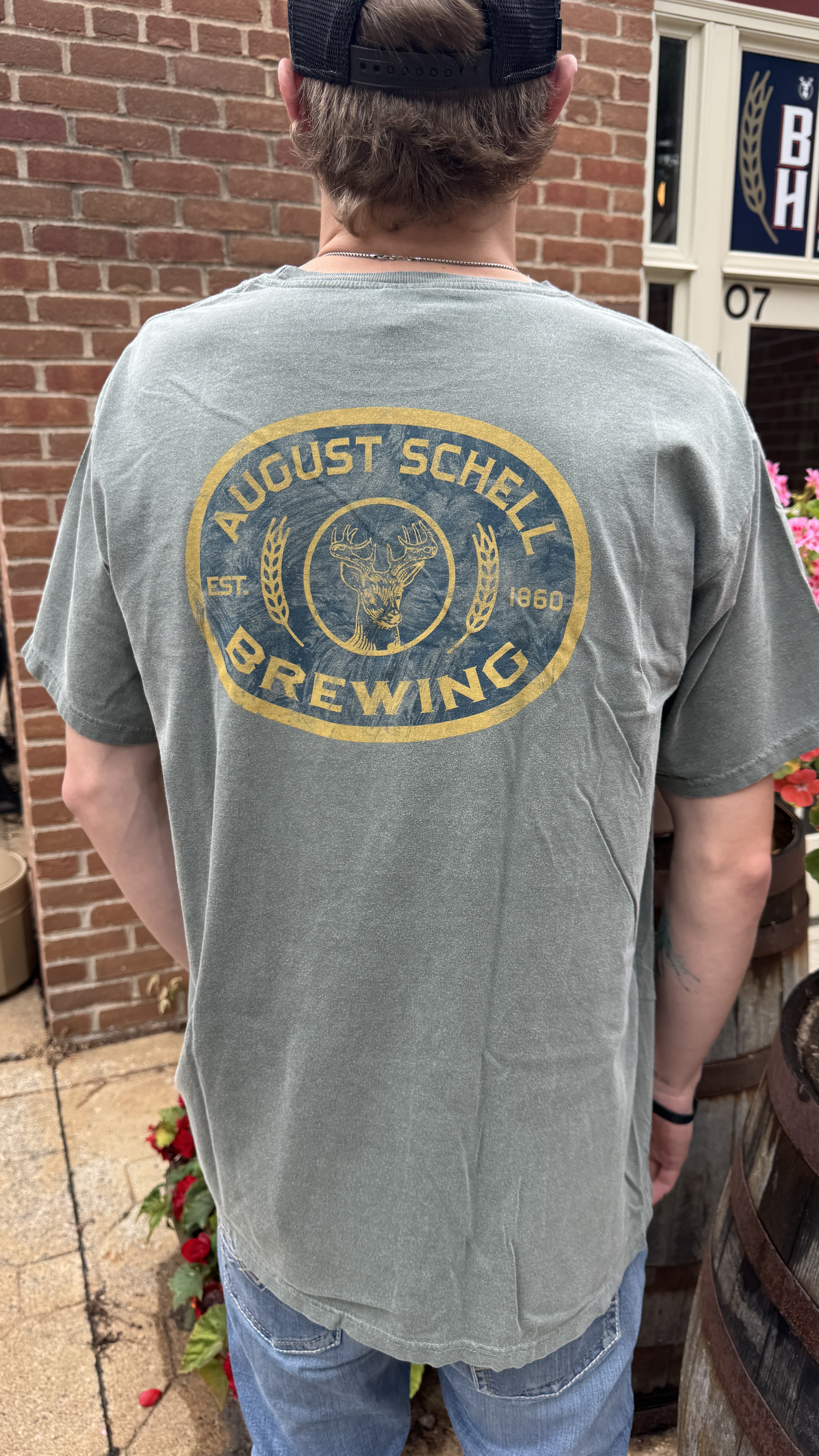 Olive colored t-shirt with Schell logo on front and back.