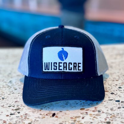 navy and grey trucker hat with a wiseacre patch