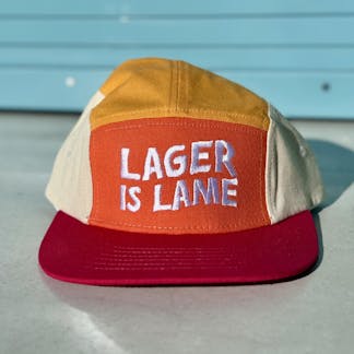 a red and orange hat that says "LAGER IS LAME"