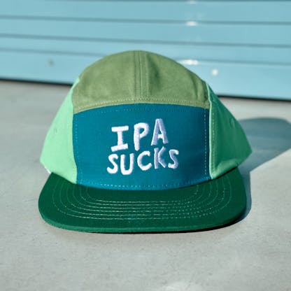 a blue and green hat that reads "IPA SUCKS"
