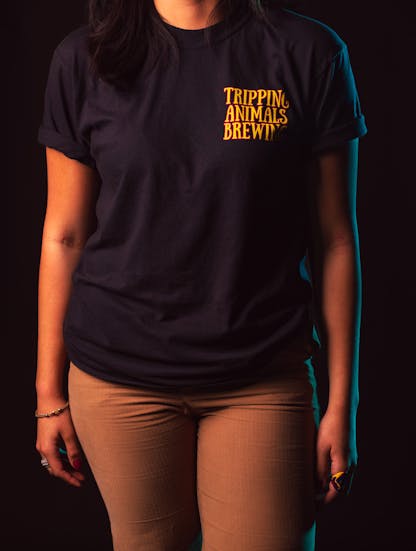A woman wearing tripping animals brewing T-shirt