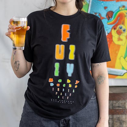 Close-up of Fuzzy Baby Ducks Eyechart T-shirt on female model holding beer