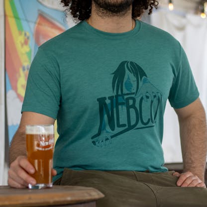 close up of green nebco x sea hag t shirt with beer in foreground