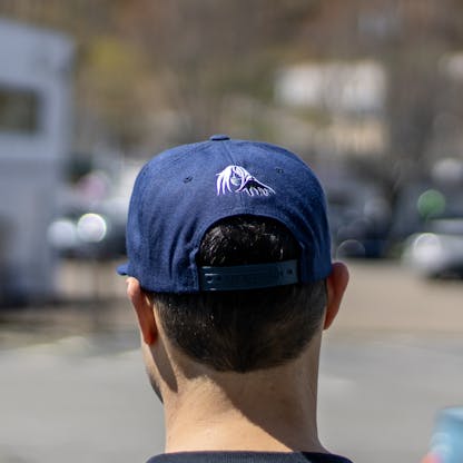 back view of navy hat on male model with Sea Hag embroidered over opening