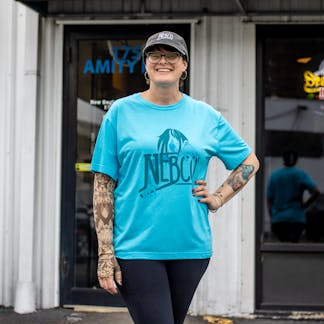 Female model wearing teal ct nebco and sea hag t shirt