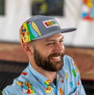 Smiling male model wearing Fuzzy Baby Ducks camper style hat