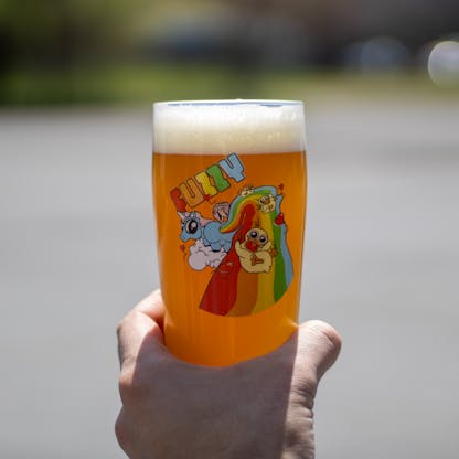 16 oz Fuzzy Pint glass being held outside