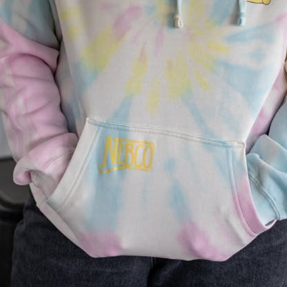 Close-up photo of yellow NEBCO state logo on front hoodie pocket of sweatshirt