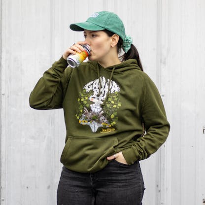 Female model drinking a beer wearing green ganja bot hooded sweatshirt