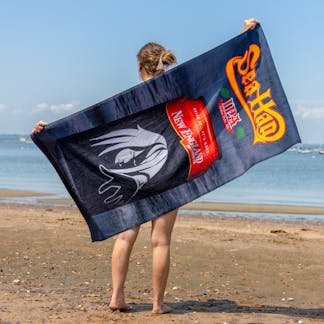 Sea Hag towel being held on the beach