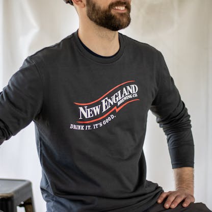 Close-up of long sleeve gray t-shirt with New England Brewing Company swoosh logo
