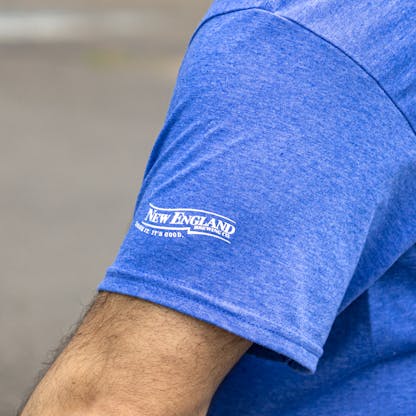 Close up of New England Brewing Company logo on blue Team Craft Beer T-shirt sleeve