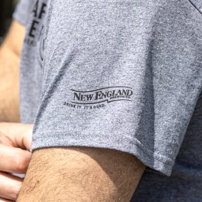 Close up of New England Brewing Company logo on gray Team Craft Beer T-shirt sleeve