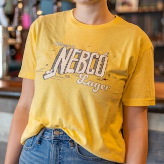 close up of yellow NEBCO Lager logo t-shirt