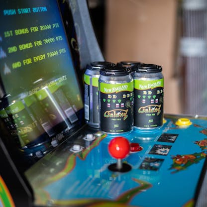 Cans of beer on top of a retro arcade machine