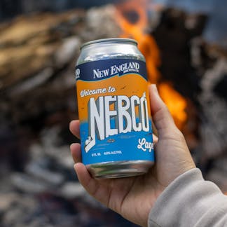 hand holding NEBCO Lager can over a fire
