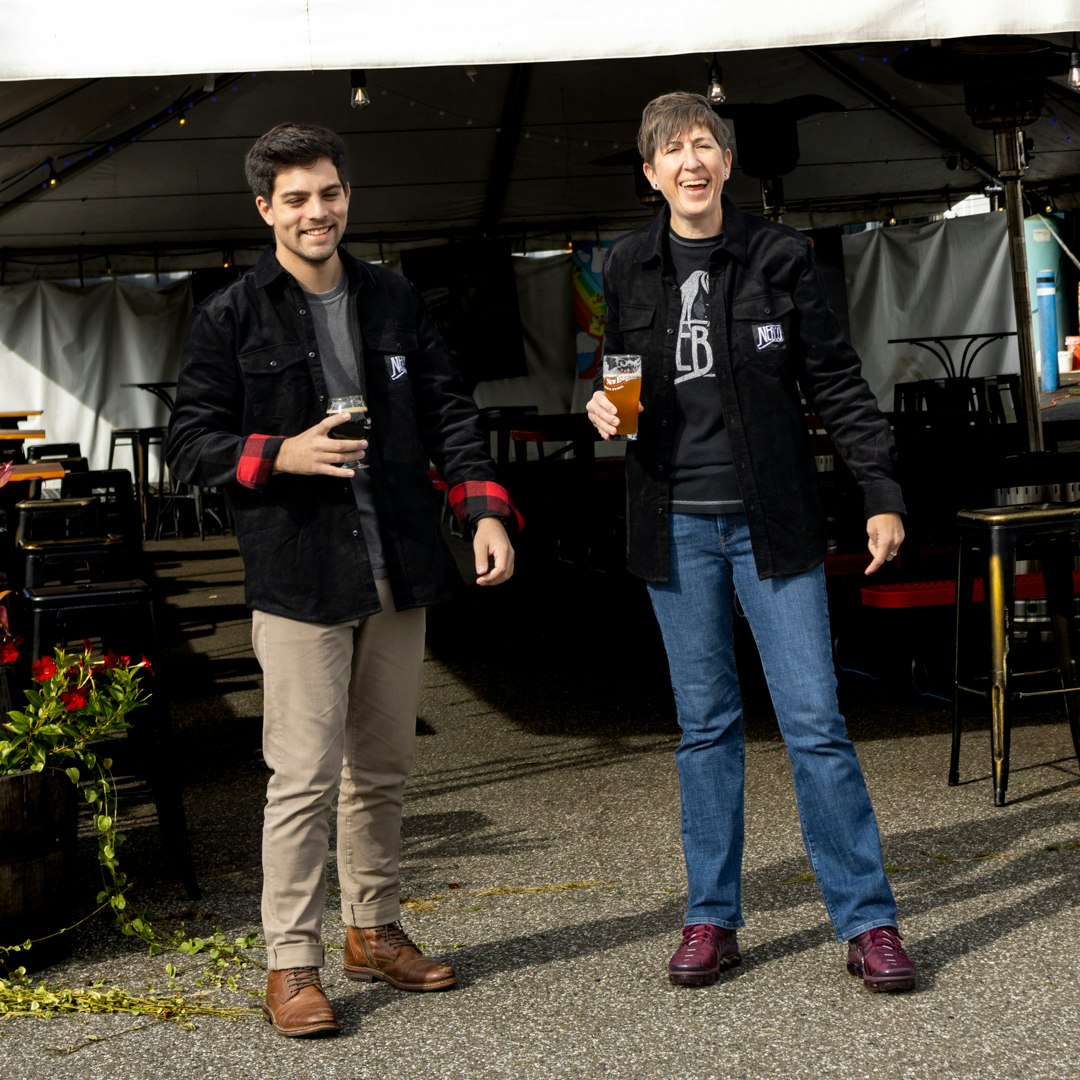 Two models wearing black corduroy jacket outdoors