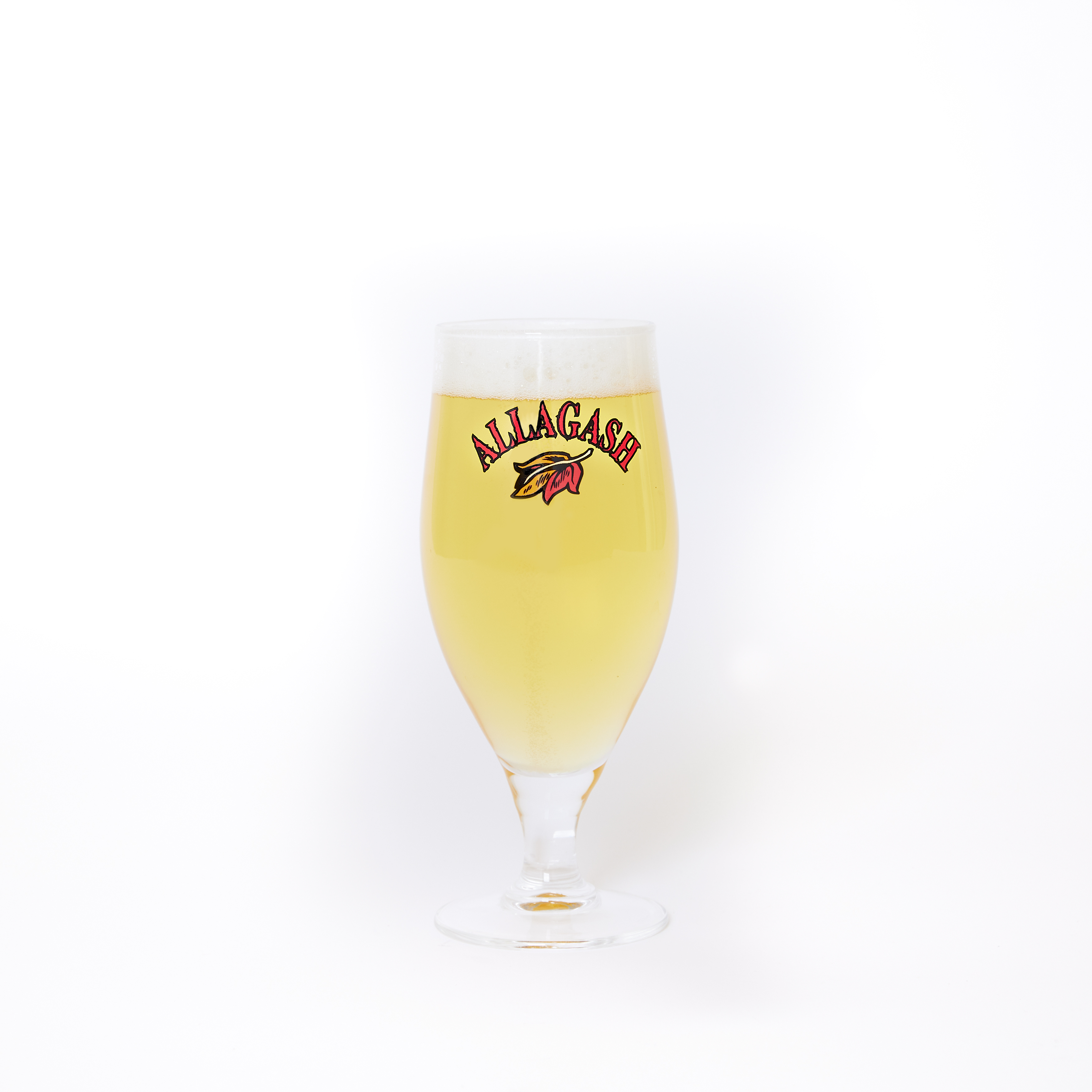 a chalice filled with beer. the front of the glass features a leaf logo and the text Allagash.