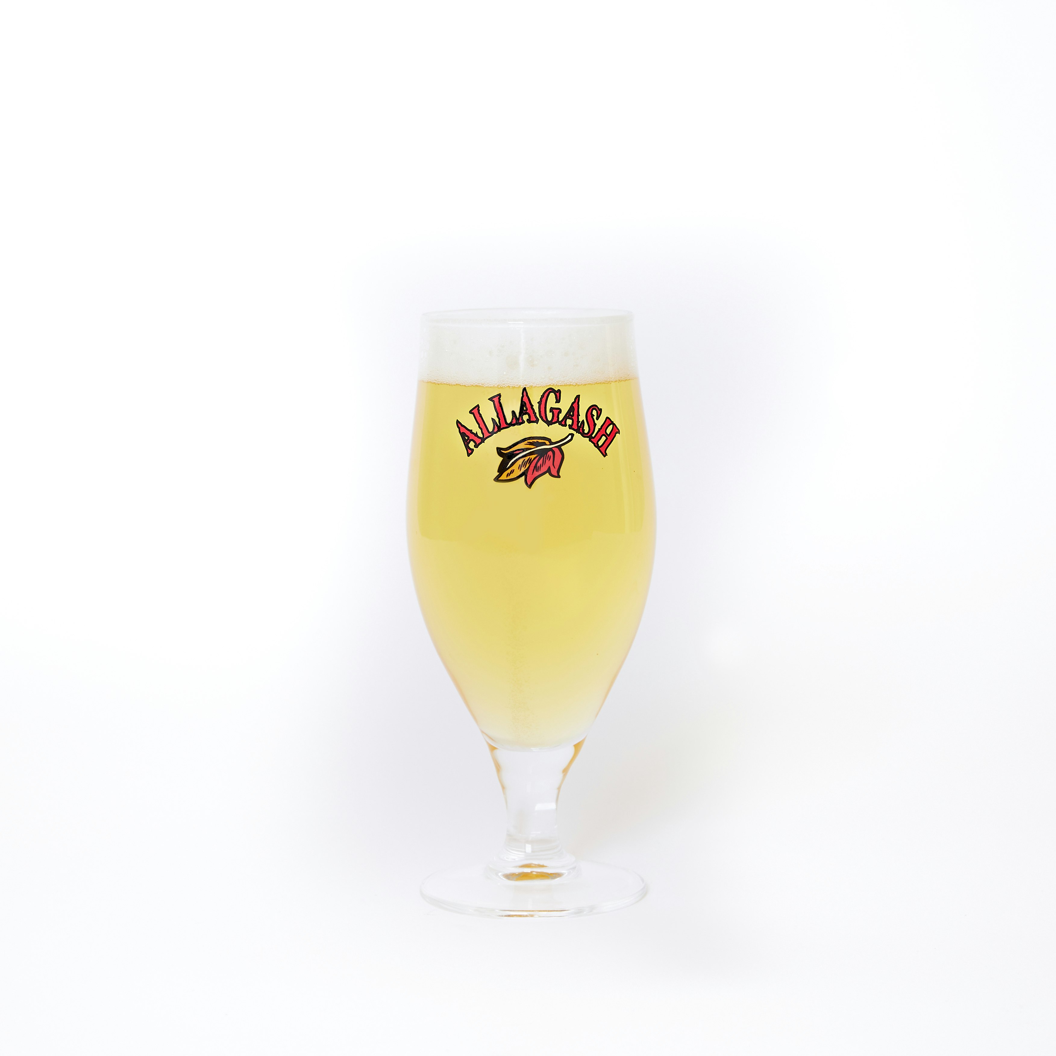 a chalice filled with beer. the front of the glass features a leaf logo and the text Allagash.