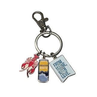 A keychain with 3 hanging trinkets. A lobster, a beer can and a flag that reads From Maine, With Love