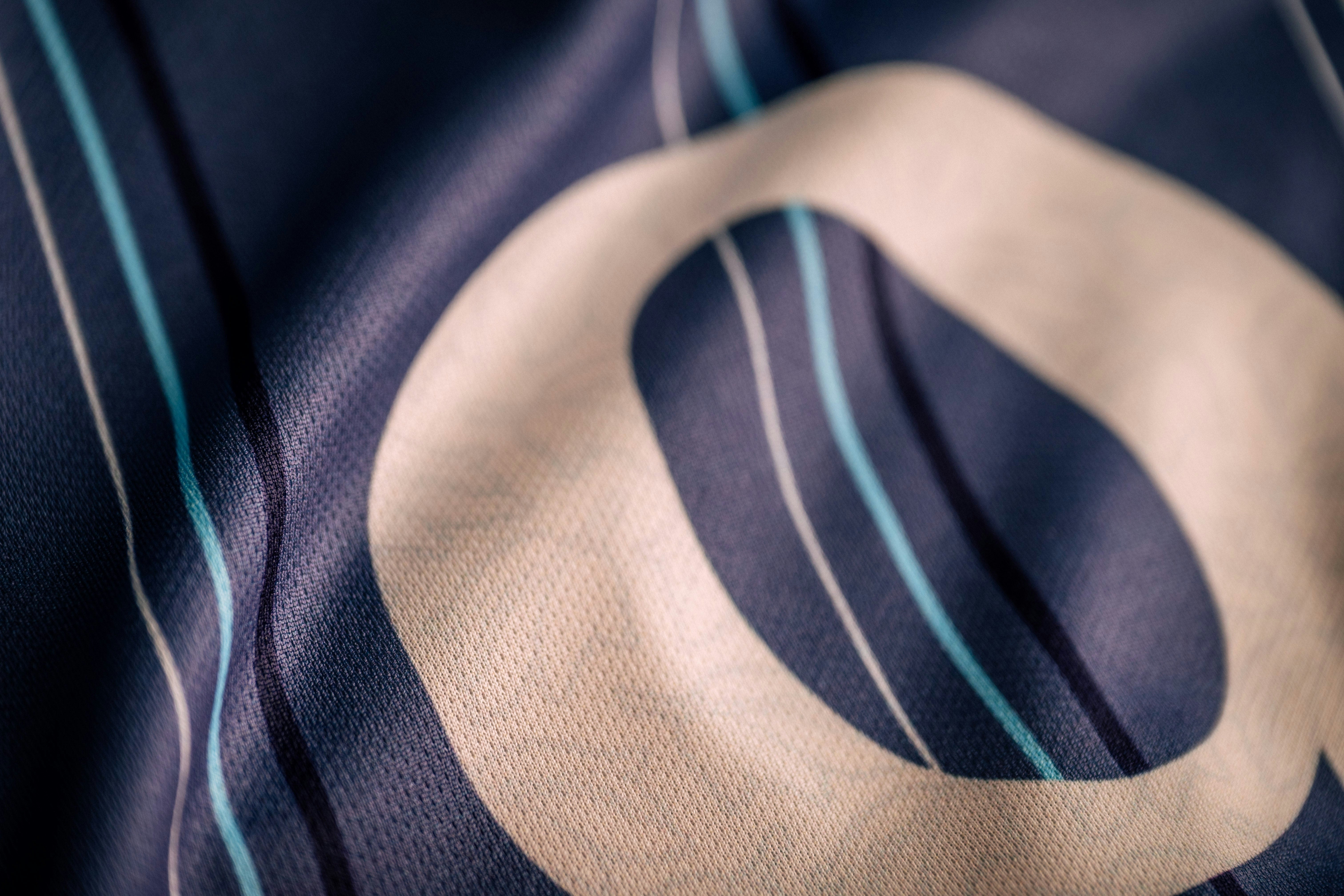 a close up of a blue stripe jersey