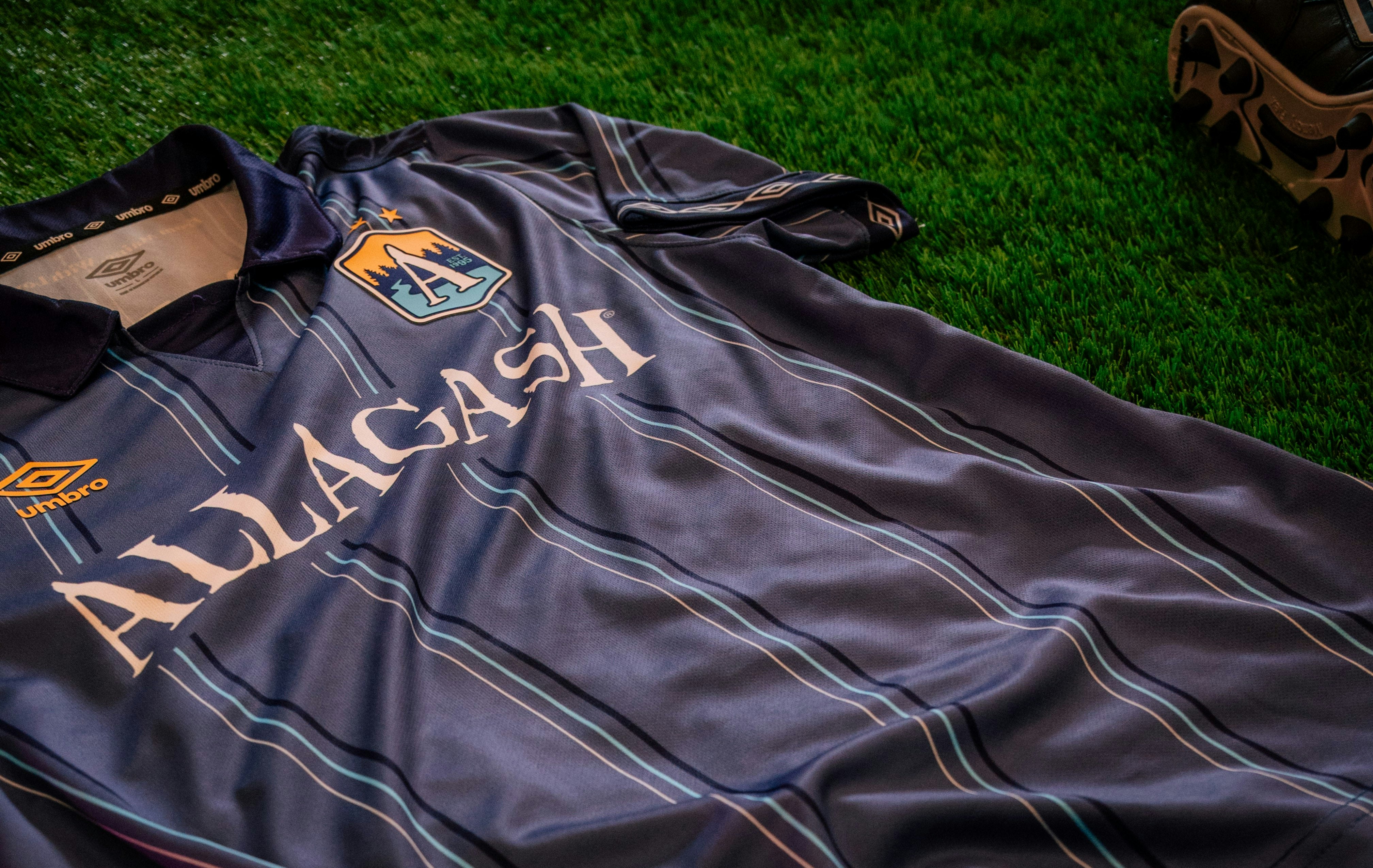 a close up of the front of a blue stripe jersey on astroturf