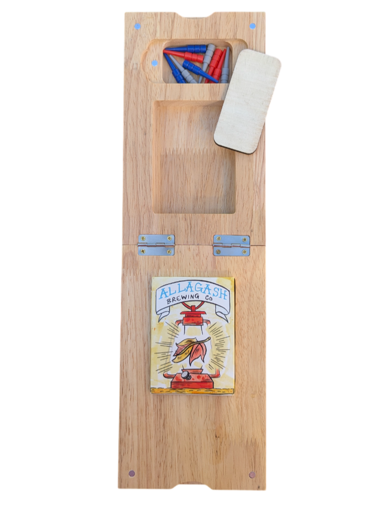 The bottom of a wooden cribbage board showing the peg and card storage