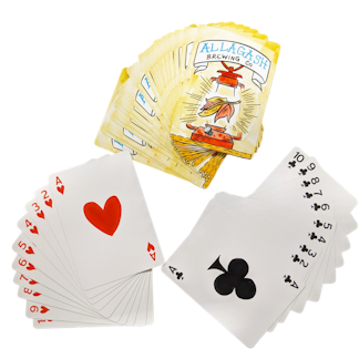 a playing card box with playing cards fanned out around it.